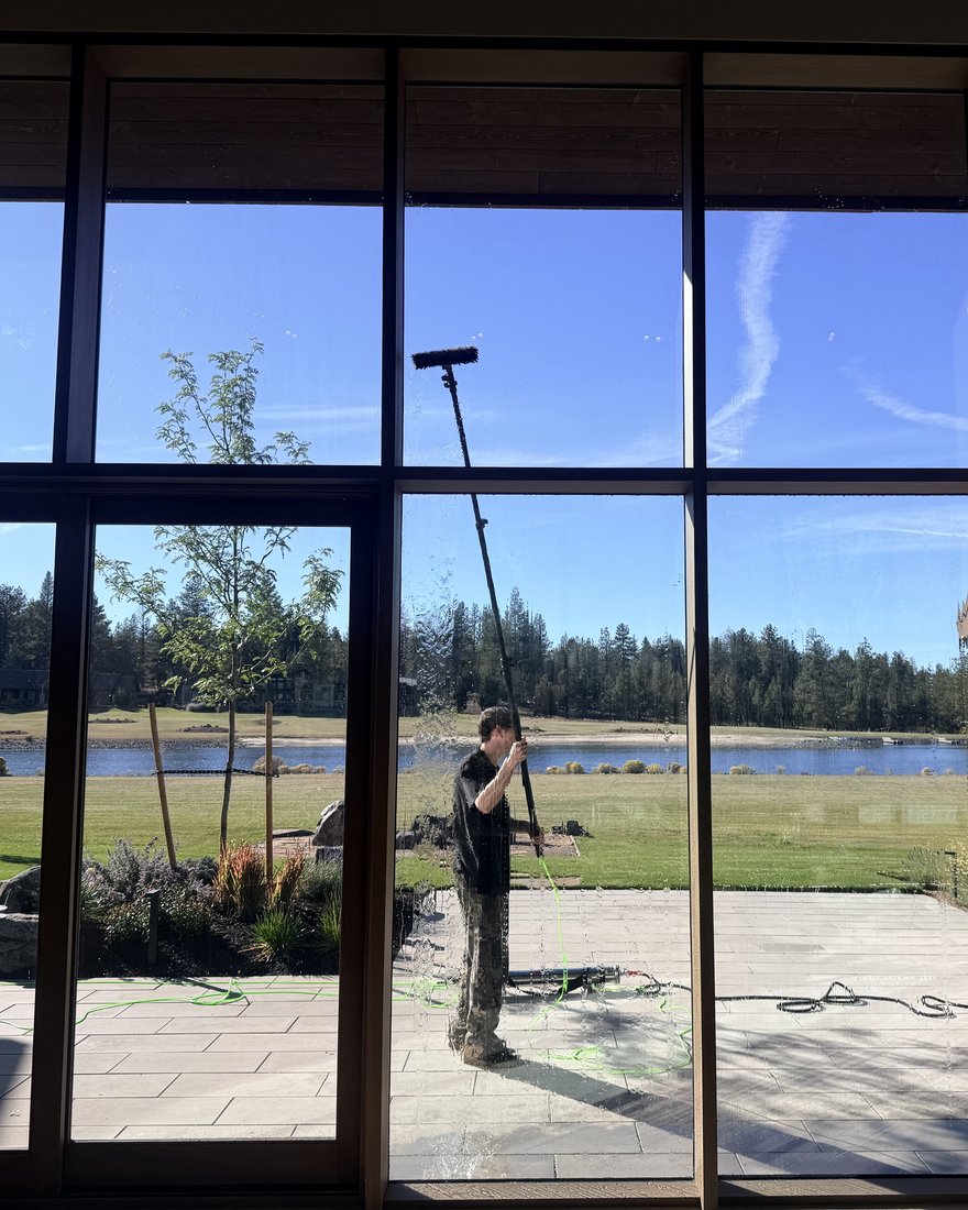 Water-fed pole reaching the upper glass on a lakeside home in Bend